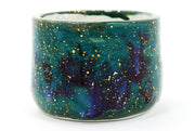 Ceramic mug with galaxy design on a white background
